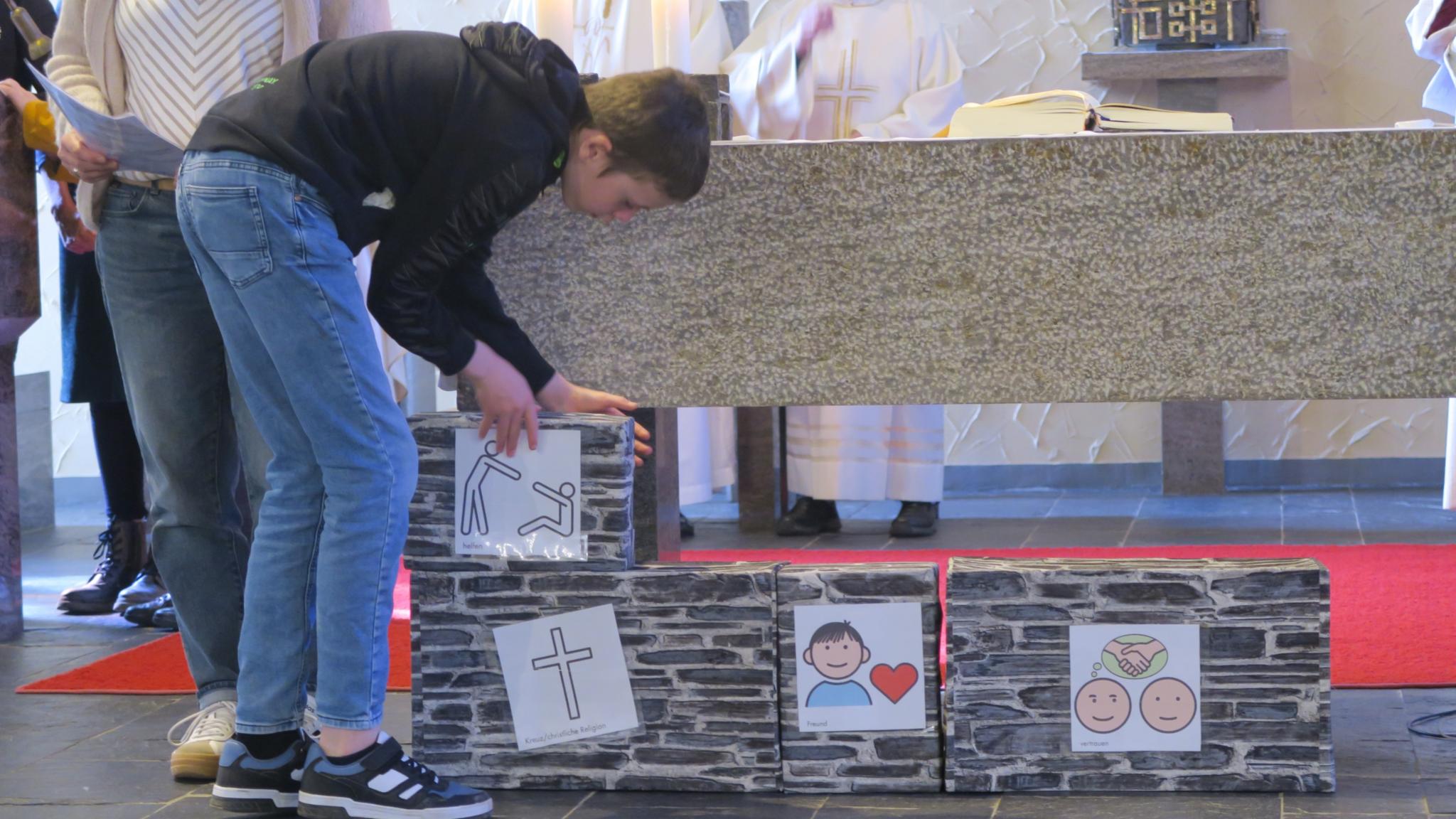 Schüler und Schülerinnen der Förderschule St. Martin bauten während des Gottesdienstes symbolisch das Haus, dessen Fundament vor 60 Jahren gelegt wurde.